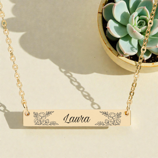 Customized necklace with name and floral engraving.