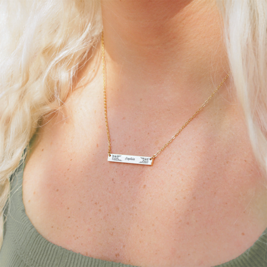 Customized necklace with name and floral engraving.